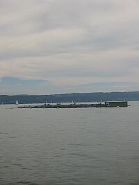 Débarcadère de Cortaillod (NE) et le Ville dEstavayer, bateau de la Société de Navigation des lacs de Neuchâtel et de Morat, voguant sur le Lac de Neuchâtel.